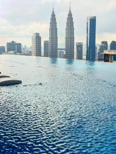 a infinity pool on the roof of a skyscraper at Eaton Residences KLCC by Luna in Kuala Lumpur