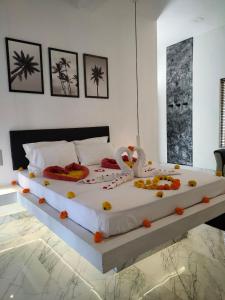 a bedroom with two large beds with decorations on them at Satta Beach Residence in Varkala