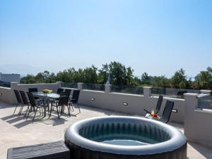 a patio with a fire pit on a roof at Villa Infinity in Kastel Novi