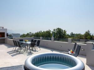 a patio with a hot tub on a roof at Villa Infinity in Kastel Novi +41 photos