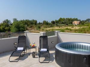 a hot tub on the roof of a house at Villa Infinity in Kastel Novi