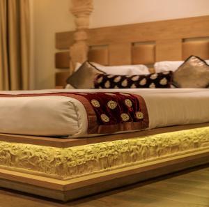 a bed is on a wooden platform in a room at Le Sutra Hotel, Khar, Mumbai in Mumbai