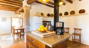 a kitchen with a bowl of fruit on a counter at Finca Can Menut in Felanitx