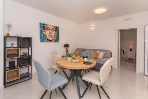 a living room with a table and chairs and a couch at Holiday home Mala in Šibenik