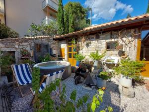 a garden with a bath tub and a house at House Rustic heaven in Novi Vinodolski