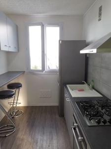 a kitchen with a stove and a counter top at apartment near the Breton coast 5 Location appartement près des côtes bretonnes in Saint-Brieuc