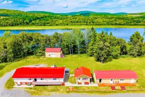 an aerial view of a house with a red roof at Love Hotels St John River at Fort Kent ME in Saint John