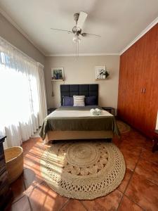 a bedroom with a large bed and a rug at Spacious 2-bed, 2-bath villa with garden and parking in Mataffin