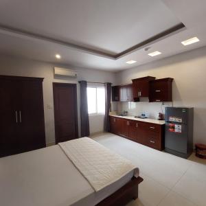 a large room with a bed and a kitchen at Biển Vàng - New Golden Sea in Vung Tau