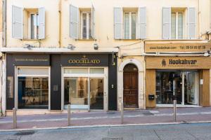 a row of store fronts on a city street at CMG - Bel appartement - 5 min à pied du Palais des Festivals in Cannes