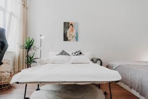 a white bedroom with a bed and a table at Sleek Studio minutes away from Deutsches Eck in Koblenz