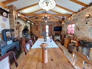 a dining room with a wooden table and a fireplace at House Rustic heaven in Novi Vinodolski