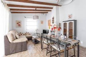 a living room with a table and a couch at Villa Benama in Torrox