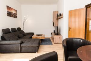 a living room with a couch and a table at Central-Inn Werfen in Werfen