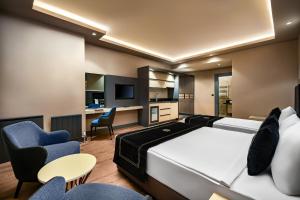 a hotel room with a bed and chairs at Hidden Hills Hotel Istanbul Airport in Istanbul