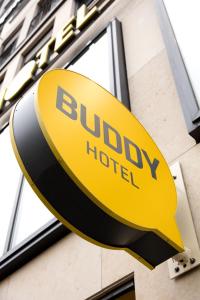 a yellow and black sign for a hotel at Buddy Hotel in Munich