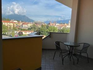 a balcony with a table and chairs and a view at RIVE DORA IVREA in Ivrea