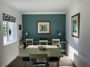 a dining room with a table and chairs at Greenhill Farm Cape Dutch Cottage Plettenberg Bay - 1 Bedroom Private Cottage in Plettenberg Bay