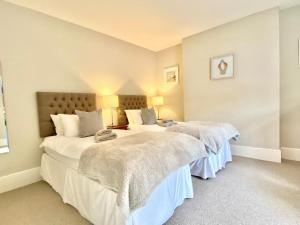 two beds in a room with white walls at St Catherine's Lookout in Niton