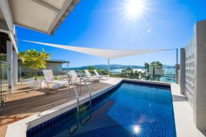 a swimming pool on the roof of a house at A Point of View in Airlie Beach