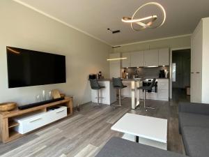 a living room with a large flat screen tv on the wall at Exclusive apartment on Fehmarn in Petersdorf auf Fehmarn