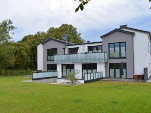 a large white house with a large yard at Exclusive apartment on Fehmarn in Petersdorf auf Fehmarn