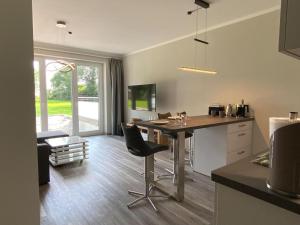 a kitchen with a table and chairs in a room at Exclusive apartment on Fehmarn in Petersdorf auf Fehmarn