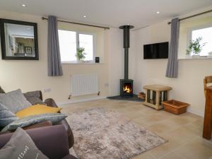 a living room with a couch and a fire place at Bryn Dedwydd Cottage in Betws-y-coed