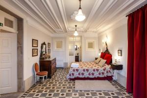 a bedroom with a bed and a chair in a room at Casa de Sequeiros in Baião