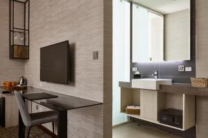 a bathroom with a sink and a mirror at Via Hotel Taipei Station in Taipei