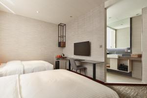 A bed or beds in a room at Via Hotel Taipei Station