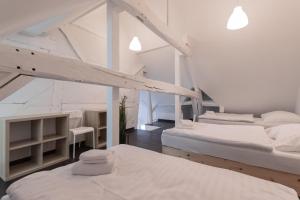 two beds in a room with white walls at T&K Apartments - Several Apartments in Wegberg in Wegberg