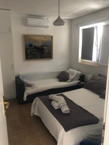 a bedroom with two beds and a painting on the wall at Apartments Zamicka in Brela