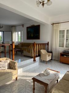a living room with a couch and a table at A cottage with lemon&orange trees! in Káto Dhiminión