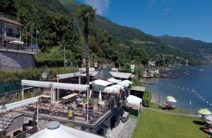 a resort with a view of a body of water at Studio 2- lake view in Oggebbio