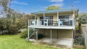a house with a porch and a balcony at Veronica Lodge Free Wifi in Inverloch