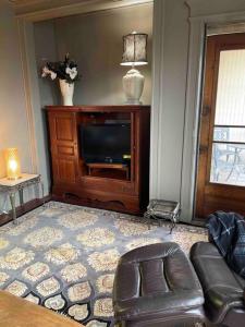 a living room with a couch and a television at Redefined Alchemy - The Studio in Little Falls