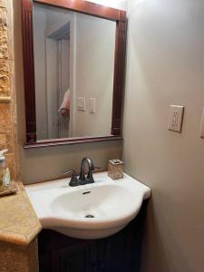 a bathroom with a sink and a mirror at Redefined Alchemy - The Studio in Little Falls