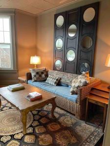 a living room with a couch and a table at Redefined Alchemy - The Studio in Little Falls