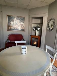 a living room with a table and chairs and a fireplace at Redefined Alchemy - The Studio in Little Falls