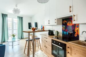 a kitchen with a counter and a table with stools at Jutrzenka in Wrocław