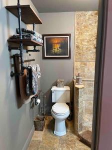 a bathroom with a toilet and a walk in shower at Redefined Alchemy - The Studio in Little Falls