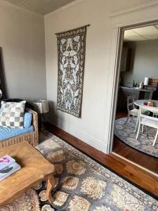 a living room with a couch and a table at Redefined Alchemy - The Studio in Little Falls