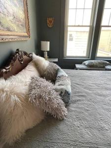 a pile of pillows laying on top of a bed at Redefined Alchemy - The Studio in Little Falls