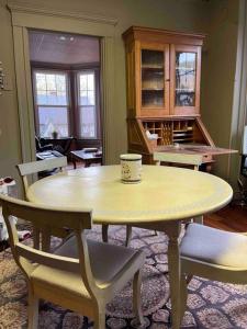a table and chairs with a coffee cup on top of it at Redefined Alchemy - The Studio in Little Falls