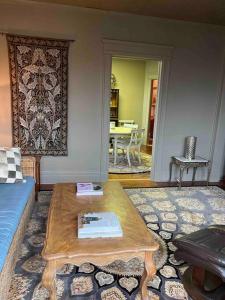 a living room with a coffee table and a dining room at Redefined Alchemy - The Studio in Little Falls