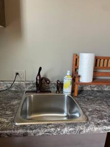 a kitchen sink with a faucet on a counter at Redefined Alchemy - The Studio in Little Falls