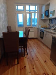 a kitchen with a table and chairs in a room at My sweet home in Qara Qarayev in Baku