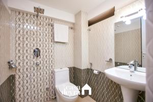 a bathroom with a toilet and a sink at Nhoo: Chhen Apartment by Casa Deyra in Pātan +24 photos