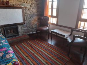 a living room with a couch and a fireplace at Şirince Lotus Konakları in Sirince